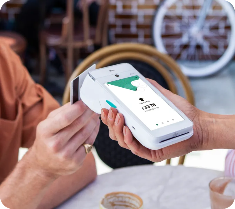 Customer paying with a contactless card on a modern terminal